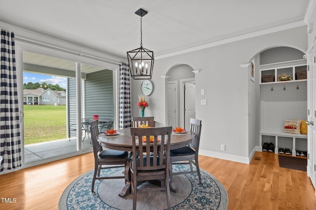 4564 Ashtons Way, Franklinton, NC 27525 - dining area with arched walkways, light wood-style flooring, ornamental molding, and baseboards
