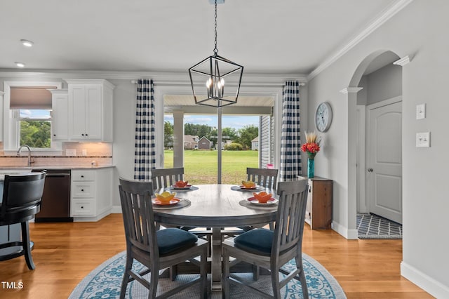 4564 Ashtons Way, Franklinton, NC 27525 - dining area featuring a chandelier, light wood-style floors, ornamental molding, baseboards, and arched walkways