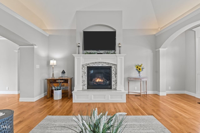 4564 Ashtons Way, Franklinton, NC 27525 - living room featuring a glass covered fireplace, decorative columns, wood finished floors, lofted ceiling, and baseboards