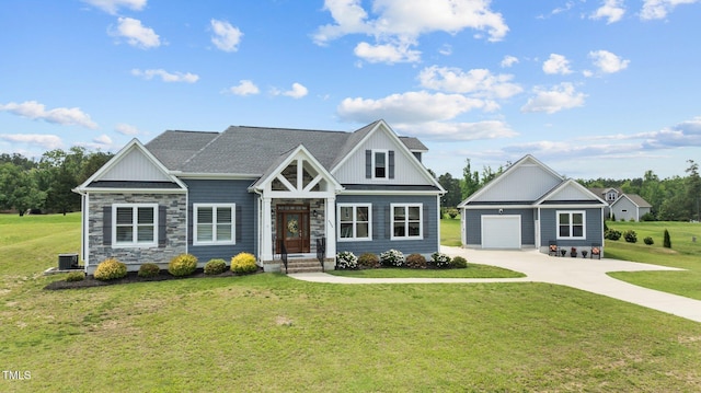 4564 Ashtons Way, Franklinton, NC 27525 - craftsman house featuring an outbuilding, a front lawn, cooling unit, concrete driveway, and stone siding
