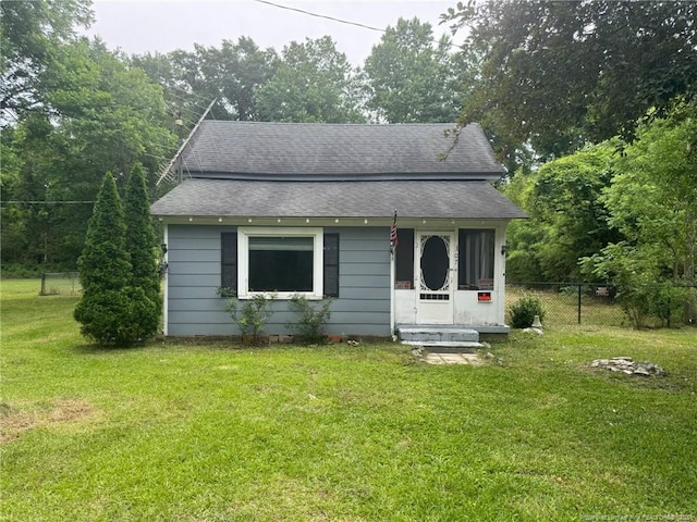 bungalow-style home with roof with shingles