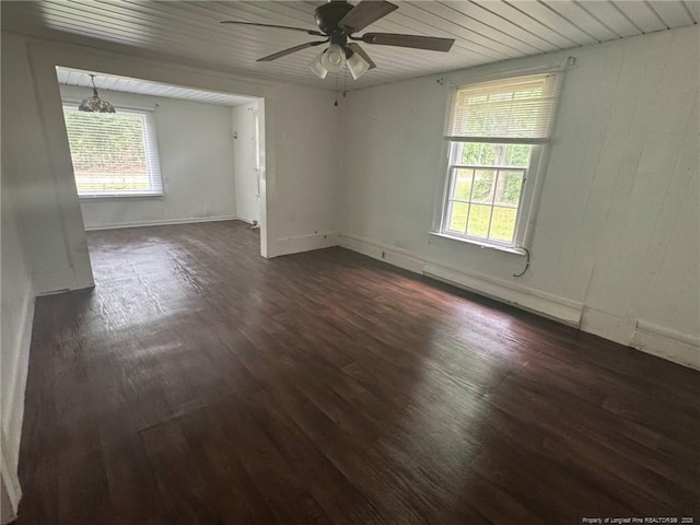unfurnished room with ceiling fan, dark wood-style floors, baseboard heating, and baseboards