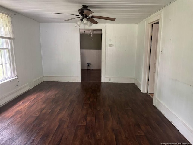 unfurnished room featuring wood finished floors, a ceiling fan, and baseboards