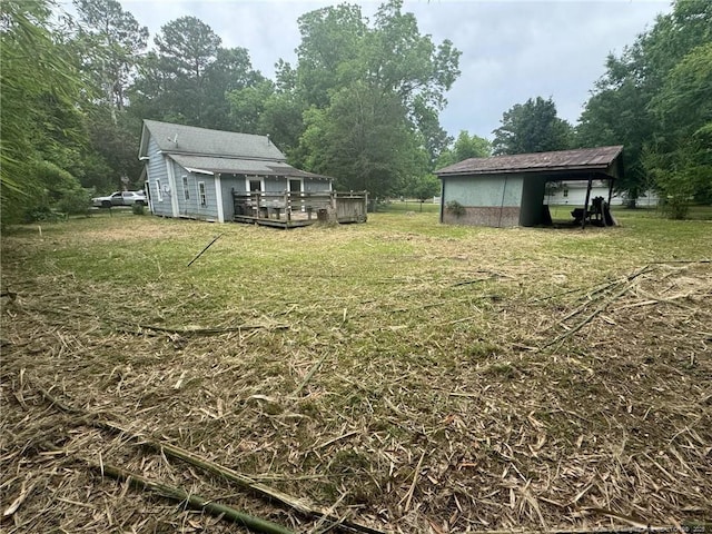 view of grassy yard featuring a deck