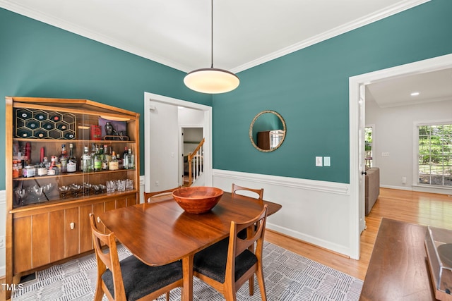 2408 Fordcrest Dr, Apex, NC 27502 - dining room featuring stairs, crown molding, wood finished floors, and wainscoting