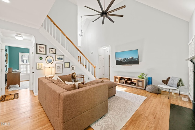 2408 Fordcrest Dr, Apex, NC 27502 - living area with stairway, ceiling fan, high vaulted ceiling, wood finished floors, and a fireplace