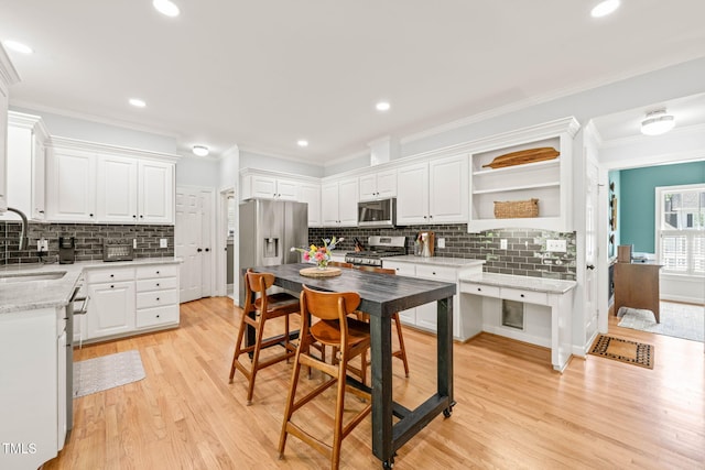 2408 Fordcrest Dr, Apex, NC 27502 - kitchen with appliances with stainless steel finishes, tasteful backsplash, light wood-style flooring, open shelves, and crown molding