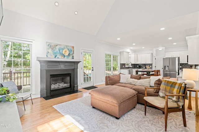 2408 Fordcrest Dr, Apex, NC 27502 - living room with light wood-style floors, a fireplace with flush hearth, recessed lighting, and lofted ceiling