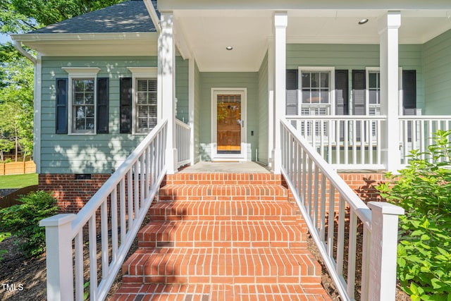 2408 Fordcrest Dr, Apex, NC 27502 - view of exterior entry with a porch, roof with shingles, and crawl space