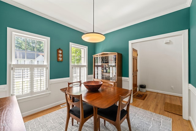 2408 Fordcrest Dr, Apex, NC 27502 - dining area with light wood-style flooring, crown molding, and a wainscoted wall
