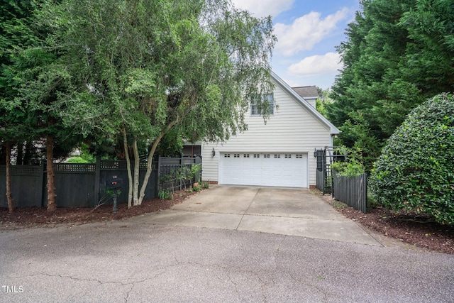 3325 Falls River Ave, Raleigh, NC 27614 - view of side of home with driveway and a garage