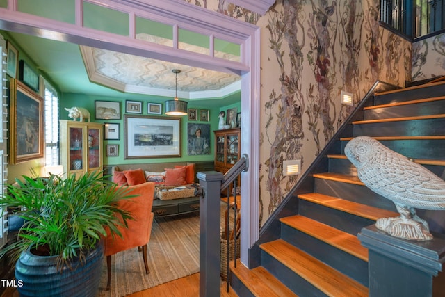 3325 Falls River Ave, Raleigh, NC 27614 - staircase with crown molding, wood finished floors, wallpapered walls, and a tray ceiling