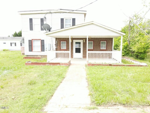 3354 Altamahaw Church St, Elon, NC 27244 - view of front of property featuring a porch, brick siding, and a front yard