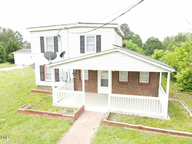3354 Altamahaw Church St, Elon, NC 27244 - view of front of house featuring covered porch, a front lawn, and brick siding