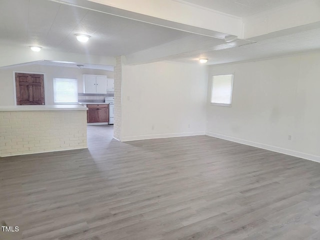 3354 Altamahaw Church St, Elon, NC 27244 - unfurnished living room featuring plenty of natural light, wood finished floors, and baseboards