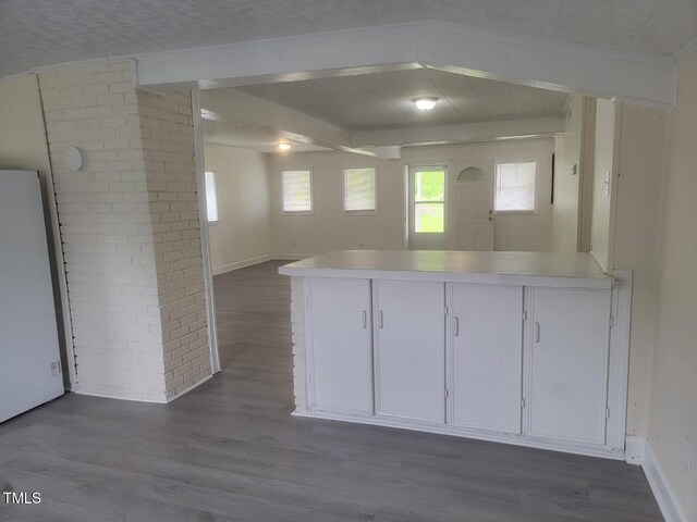 3354 Altamahaw Church St, Elon, NC 27244 - kitchen with a peninsula, dark wood finished floors, light countertops, open floor plan, and white cabinetry