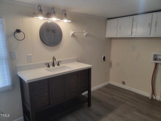 3354 Altamahaw Church St, Elon, NC 27244 - laundry room featuring hookup for a washing machine, ornamental molding, dark wood-type flooring, baseboards, and cabinet space
