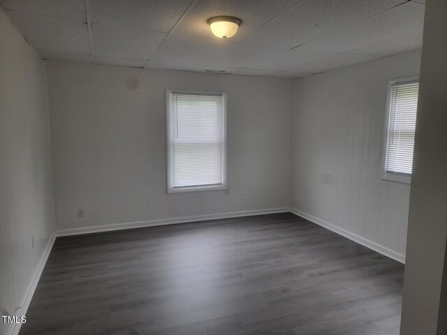 3354 Altamahaw Church St, Elon, NC 27244 - unfurnished room with baseboards, a drop ceiling, and dark wood-style floors