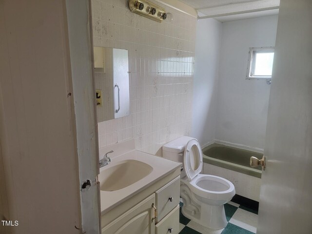3354 Altamahaw Church St, Elon, NC 27244 - bathroom with vanity, toilet, a tub to relax in, tile walls, and tasteful backsplash