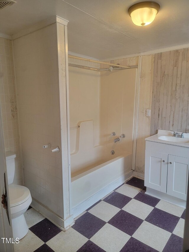 3354 Altamahaw Church St, Elon, NC 27244 - bathroom featuring tile patterned floors, wood walls, toilet, vanity, and shower / bathtub combination