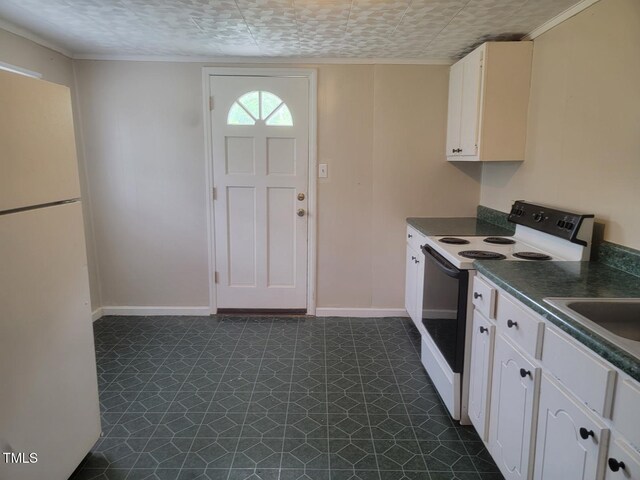 3354 Altamahaw Church St, Elon, NC 27244 - kitchen with freestanding refrigerator, range with electric cooktop, dark countertops, dark floors, and baseboards