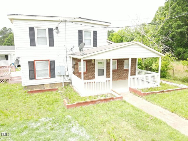 3354 Altamahaw Church St, Elon, NC 27244 - view of front of house featuring a porch, a front yard, and brick siding