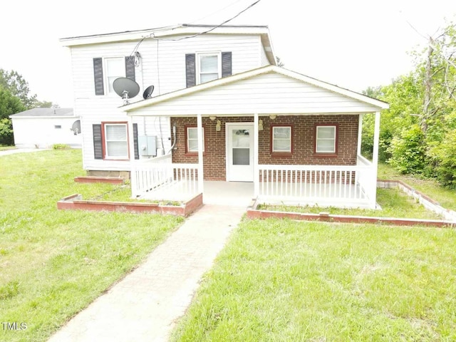 3354 Altamahaw Church St, Elon, NC 27244 - view of front of home with a porch, brick siding, and a front lawn