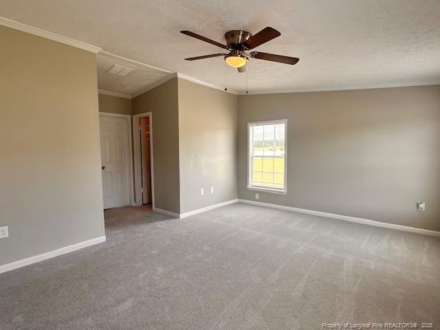 unfurnished room featuring baseboards, ornamental molding, a ceiling fan, and carpet flooring