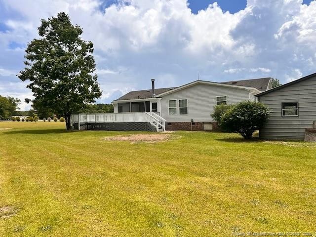 rear view of property with a yard and crawl space