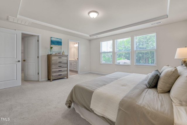 1007 Sora Way, Durham, NC 27703 - bedroom with a tray ceiling, light colored carpet, baseboards, and ensuite bath