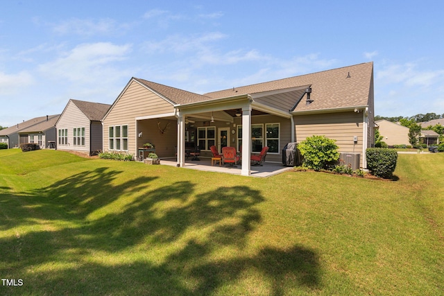 211 Ibis Ln, Durham, NC 27703 - back of house with ceiling fan, a patio area, a yard, and a shingled roof