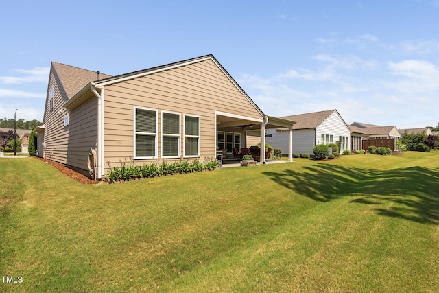 211 Ibis Ln, Durham, NC 27703 - rear view of house with a yard and a patio
