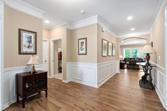 211 Ibis Ln, Durham, NC 27703 - hallway featuring arched walkways, wainscoting, wood finished floors, ornamental molding, and recessed lighting
