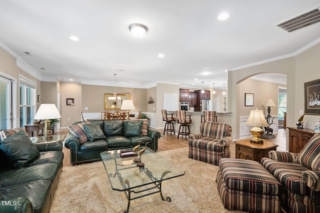 211 Ibis Ln, Durham, NC 27703 - living area featuring ornamental molding, recessed lighting, arched walkways, light wood-type flooring, and a chandelier