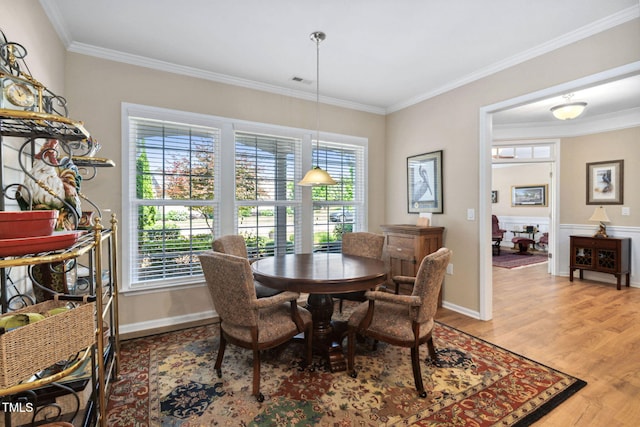 211 Ibis Ln, Durham, NC 27703 - dining area with light wood-style flooring, crown molding, and baseboards