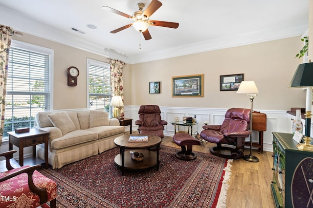 211 Ibis Ln, Durham, NC 27703 - living area featuring light wood-style floors, ceiling fan, crown molding, and a wainscoted wall