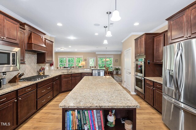 211 Ibis Ln, Durham, NC 27703 - kitchen featuring stainless steel appliances, a sink, custom range hood, light wood-type flooring, and a center island