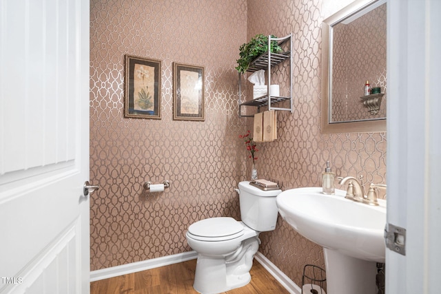 211 Ibis Ln, Durham, NC 27703 - half bathroom featuring wallpapered walls, toilet, wood finished floors, and a sink