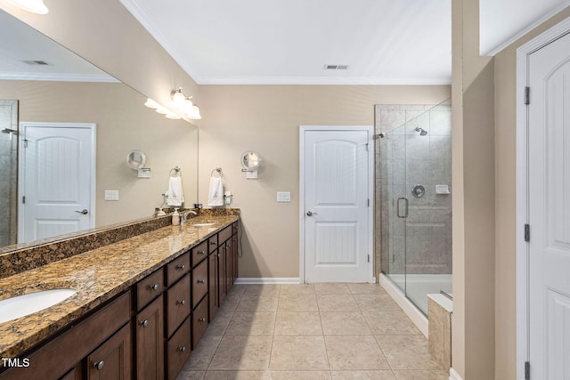 211 Ibis Ln, Durham, NC 27703 - bathroom featuring a stall shower, double vanity, crown molding, baseboards, and tile patterned floors