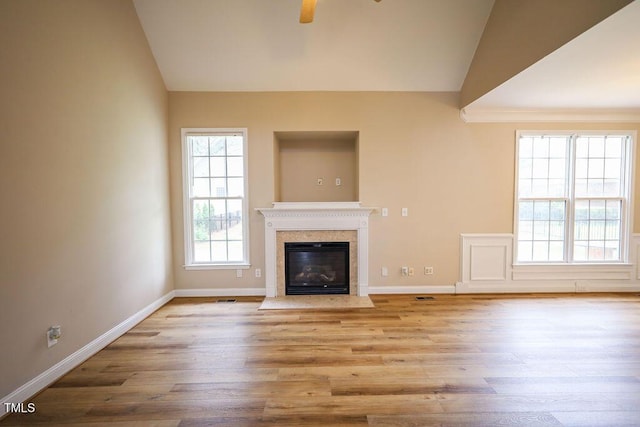 10 London Way, Spring Lake, NC 28390 - unfurnished living room featuring vaulted ceiling, baseboards, ceiling fan, wood finished floors, and a fireplace with flush hearth