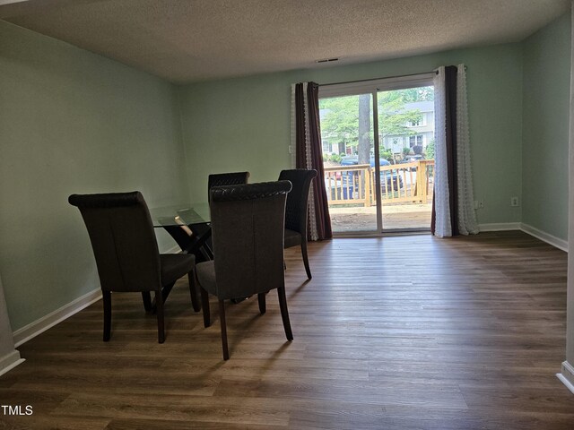 7719 Kingsberry Ct, Raleigh, NC 27615 - dining room with dark wood-type flooring, baseboards, and a textured ceiling