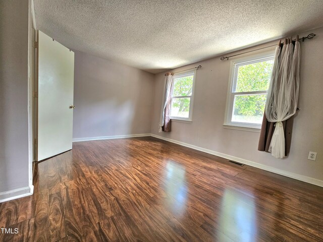 7719 Kingsberry Ct, Raleigh, NC 27615 - empty room with a textured ceiling, wood finished floors, and baseboards