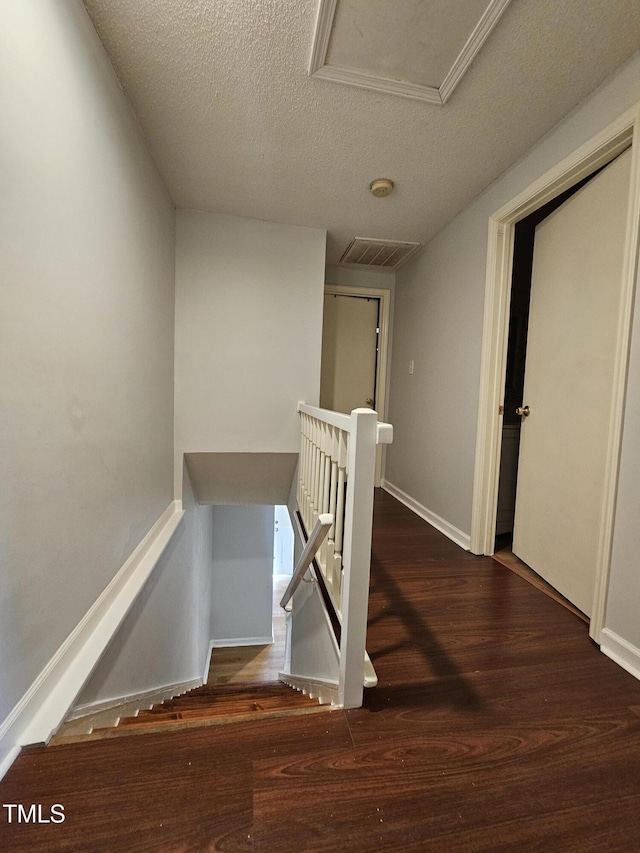 7719 Kingsberry Ct, Raleigh, NC 27615 - stairway with a textured ceiling, wood finished floors, baseboards, and attic access