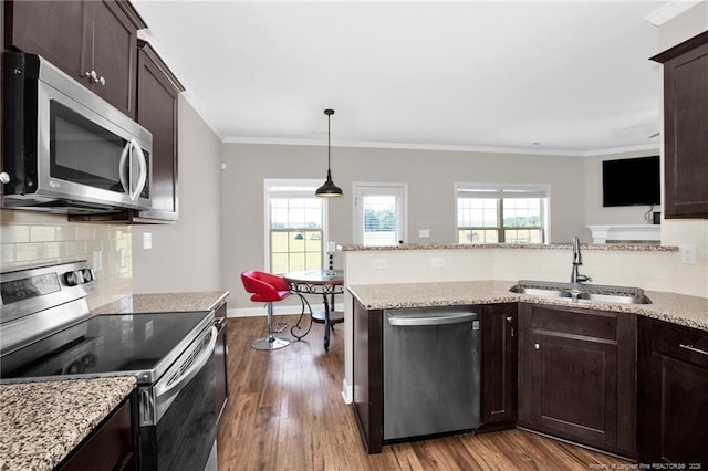 341 Woodington Rd, Hope Mills, NC 28348 - kitchen featuring stainless steel appliances, a sink, dark brown cabinets, dark wood finished floors, and decorative backsplash