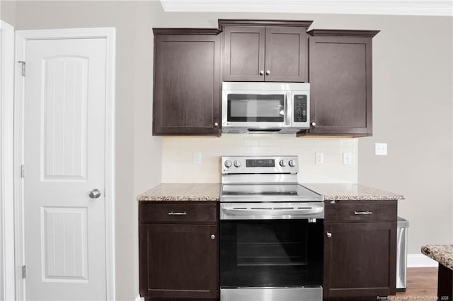341 Woodington Rd, Hope Mills, NC 28348 - kitchen featuring appliances with stainless steel finishes, dark brown cabinets, tasteful backsplash, and light stone counters