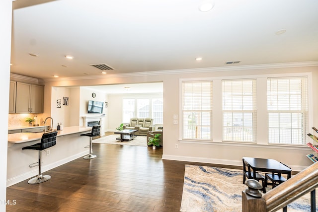 2918 Heirloom Way, Apex, NC 27502 - living room featuring crown molding, dark wood-type flooring, a fireplace, baseboards, and recessed lighting