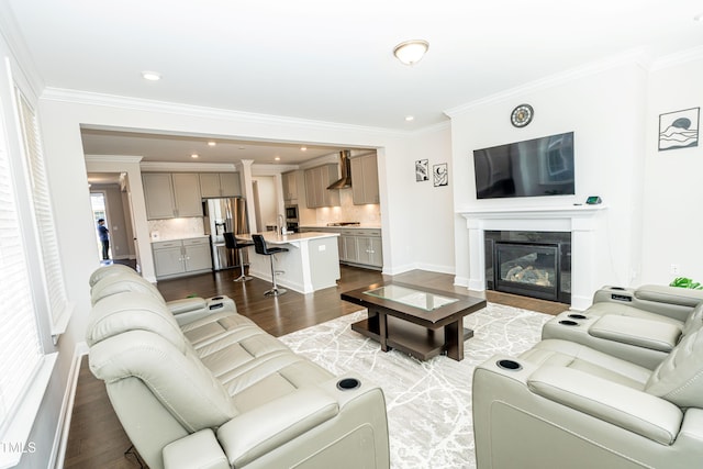 2918 Heirloom Way, Apex, NC 27502 - living room featuring ornamental molding, wood finished floors, a glass covered fireplace, recessed lighting, and baseboards