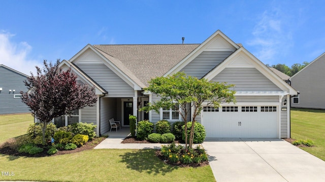 1112 Monterey Bay Dr, Wake Forest, NC 27587 - view of front of home featuring a garage, concrete driveway, a front lawn, and a shingled roof