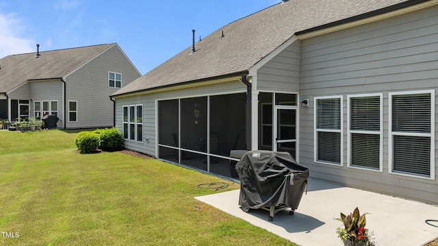 1112 Monterey Bay Dr, Wake Forest, NC 27587 - back of house with a sunroom, a patio, a yard, and roof with shingles