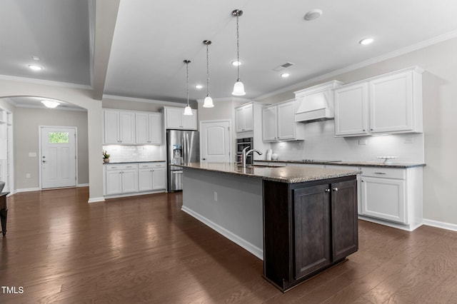 1112 Monterey Bay Dr, Wake Forest, NC 27587 - kitchen featuring stainless steel fridge with ice dispenser, custom range hood, a sink, arched walkways, and crown molding